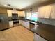 Bright kitchen features stainless steel appliances, white cabinetry and views of the outdoor pool at 9615 N 34Th Ave, Phoenix, AZ 85051