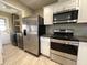 Updated kitchen features stainless steel appliances, stylish cabinets, and adjacent laundry area at 9615 N 34Th Ave, Phoenix, AZ 85051