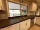 Stylish kitchen featuring a stainless steel sink, white cabinets, and a granite countertop at 9615 N 34Th Ave, Phoenix, AZ 85051