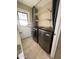 Well-organized laundry room with modern washer and dryer, shelving, and tile flooring at 9615 N 34Th Ave, Phoenix, AZ 85051