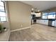Spacious living area with tile flooring and an open layout, featuring natural light from the large window at 9615 N 34Th Ave, Phoenix, AZ 85051