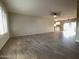 Bright living room featuring tile flooring, fan, and natural light from large windows and an open layout to the kitchen at 9615 N 34Th Ave, Phoenix, AZ 85051