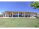 Large backyard with covered patio, barbecue, seating, and well manicured grass at 9759 E Brown Rd, Mesa, AZ 85207