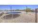 Large backyard featuring a trampoline, gravel, and fencing at 9759 E Brown Rd, Mesa, AZ 85207