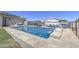 Backyard featuring a sparkling pool, lawn, a fence, and assorted utility vehicles at 9759 E Brown Rd, Mesa, AZ 85207