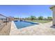 Beautiful backyard featuring a pool with stone surround, nice lawn and partial fencing at 9759 E Brown Rd, Mesa, AZ 85207