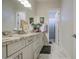 Bright bathroom featuring marble floors, double sinks, and white cabinets at 9759 E Brown Rd, Mesa, AZ 85207