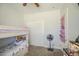 Bright bedroom featuring a bunk bed, neutral walls, and a closet with plenty of space at 9759 E Brown Rd, Mesa, AZ 85207