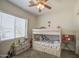 A cozy ' bedroom with a bunk bed, a window with blinds, and a ceiling fan at 9759 E Brown Rd, Mesa, AZ 85207