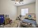 This bedroom features a ceiling fan, a wooden bed frame, and a blue gaming chair at 9759 E Brown Rd, Mesa, AZ 85207