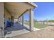 Large covered patio with barbecue overlooks a spacious backyard with grass and gravel areas at 9759 E Brown Rd, Mesa, AZ 85207