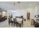 Dining area connecting to the living room and featuring hardwood floors and closet access at 9759 E Brown Rd, Mesa, AZ 85207