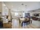 Open-concept kitchen and living area with hardwood floors, stainless steel appliances, and bright lighting at 9759 E Brown Rd, Mesa, AZ 85207