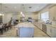 Well-lit kitchen featuring a large island with granite countertops and stainless steel appliances at 9759 E Brown Rd, Mesa, AZ 85207