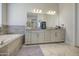 Elegant main bathroom featuring dual sinks, granite countertops, ample storage, and a relaxing ambiance at 9759 E Brown Rd, Mesa, AZ 85207