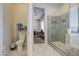 The main bathroom has a toilet, glass shower and a small area that can be used for storage and toiletries at 9759 E Brown Rd, Mesa, AZ 85207
