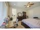Light-filled main bedroom features a ceiling fan, workspace, and ensuite bath for added comfort and privacy at 9759 E Brown Rd, Mesa, AZ 85207