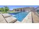 Inviting backyard oasis with refreshing pool, waterfall feature, and ample space for outdoor entertaining at 9759 E Brown Rd, Mesa, AZ 85207