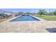 A backyard pool with a tiled deck and waterfall feature enhances outdoor living at 9759 E Brown Rd, Mesa, AZ 85207