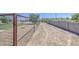Gravel side yard enclosed with a chain link fence and CMU block perimeter fence at 9759 E Brown Rd, Mesa, AZ 85207