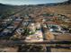 An aerial shot offering a comprehensive view of a sprawling desert property, complete with pool and various outbuildings at 1044 E Irvine Rd, Phoenix, AZ 85086