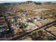 This aerial view showcases the equestrian property with horse facilities, homes, and beautiful desert surroundings at 1044 E Irvine Rd, Phoenix, AZ 85086