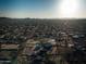 This aerial view shows the sprawling community with equestrian facilities, homes, and stunning views of the surrounding desert at 1044 E Irvine Rd, Phoenix, AZ 85086