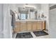 This bathroom has a double sink vanity, large mirror, and neutral tile at 1044 E Irvine Rd, Phoenix, AZ 85086