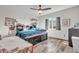 This bedroom features wood-look tile flooring, ceiling fan and a window at 1044 E Irvine Rd, Phoenix, AZ 85086
