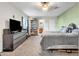 Spacious bedroom with carpet floors, a large dresser with TV, and access to the bathroom, offering comfort and convenience at 1044 E Irvine Rd, Phoenix, AZ 85086
