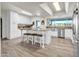 Modern kitchen with white cabinets, granite countertops, stainless steel appliances, and an island with seating at 1044 E Irvine Rd, Phoenix, AZ 85086