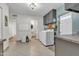 Well-lit laundry room featuring tile floors, cabinets and washer/dryer, plus access to a bathroom and exterior door at 1044 E Irvine Rd, Phoenix, AZ 85086