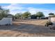 Property entrance with a long, winding drive and desert landscaping leading to a home with an attached garage at 1044 E Irvine Rd, Phoenix, AZ 85086