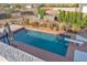 Backyard pool surrounded by desert landscaping, offering a refreshing oasis with a diving board and umbrella at 1044 E Irvine Rd, Phoenix, AZ 85086
