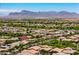 Scenic aerial view of a neighborhood with mountain backdrop, homes, and well-manicured streets in a vibrant community at 10618 E Kinetic Dr, Mesa, AZ 85212
