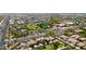 Aerial view showing a community with a pool, sport courts, schools, lush landscaping, and well-maintained roadways at 10618 E Kinetic Dr, Mesa, AZ 85212