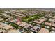 Aerial view of a neighborhood showcasing single-Gathering homes, mature trees, community green space, and residential streets at 10618 E Kinetic Dr, Mesa, AZ 85212