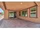 Beautiful covered patio with brick flooring, enhancing outdoor living and entertaining at 10618 E Kinetic Dr, Mesa, AZ 85212