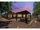 A backyard featuring a pergola with seating, and a patch of artificial grass providing an inviting outdoor space at 10618 E Kinetic Dr, Mesa, AZ 85212