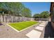 A well maintained backyard featuring synthetic grass, desert landscaping and a pergola at 10618 E Kinetic Dr, Mesa, AZ 85212