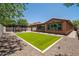 Low maintenance backyard featuring synthetic grass, a pergola and desert landscaping at 10618 E Kinetic Dr, Mesa, AZ 85212