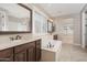 Elegant bathroom showcasing double sinks, soaking tub, and a separate walk-in shower at 10618 E Kinetic Dr, Mesa, AZ 85212