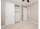 Bedroom boasts closet space, neutral carpet, and is conveniently located near an ensuite bathroom at 10618 E Kinetic Dr, Mesa, AZ 85212