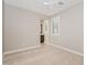 A neutral-toned bedroom featuring plush carpeting, a ceiling fan and access to a full ensuite bathroom at 10618 E Kinetic Dr, Mesa, AZ 85212