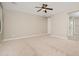 Generously sized bedroom offers neutral palette and lots of natural light from ample windows at 10618 E Kinetic Dr, Mesa, AZ 85212