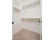 A carpeted closet with white walls and shelving, offering ample storage space at 10618 E Kinetic Dr, Mesa, AZ 85212