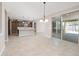 Open-concept dining area with sliding glass doors leading to the patio and view of the kitchen at 10618 E Kinetic Dr, Mesa, AZ 85212