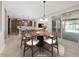 Bright dining area features a round table with seating for six, and sliding door access to the outdoor patio at 10618 E Kinetic Dr, Mesa, AZ 85212