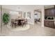 Stylishly staged dining area with a round table and seating, adjacent to the living room at 10618 E Kinetic Dr, Mesa, AZ 85212