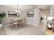 Staged dining room featuring a modern chandelier, neutral tones, and a view into the hallway at 10618 E Kinetic Dr, Mesa, AZ 85212